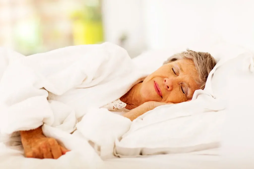 An old lady sleeping on bed.