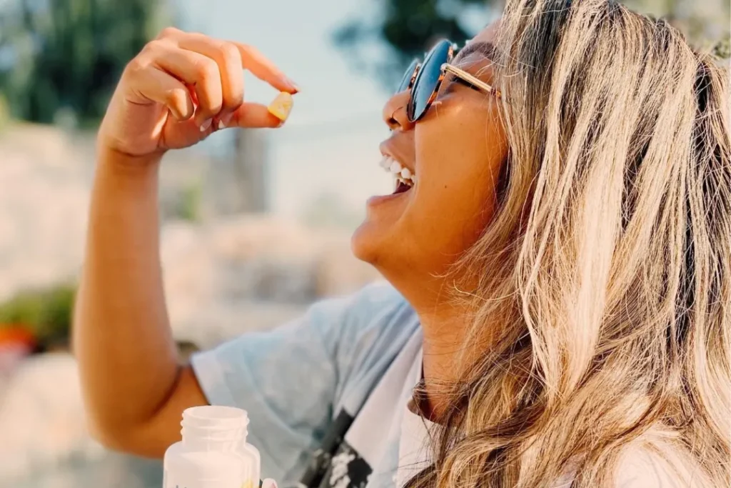 Woman intaking CBD gummies